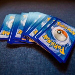 A set of Pokémon cards displayed on a blue surface, perfect for game enthusiasts.